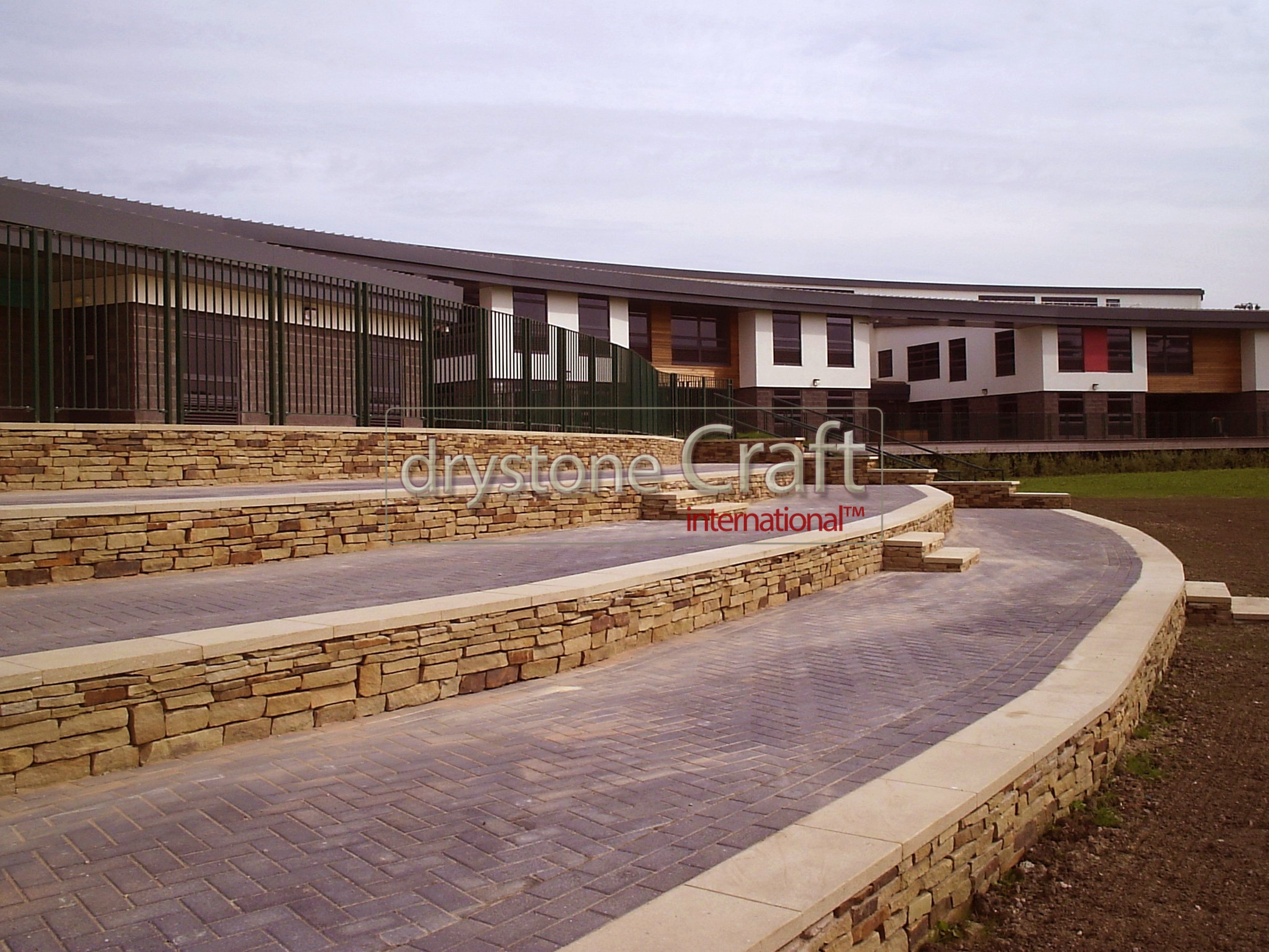 Stone clad retaining walls with stone flag tops unity college burnley